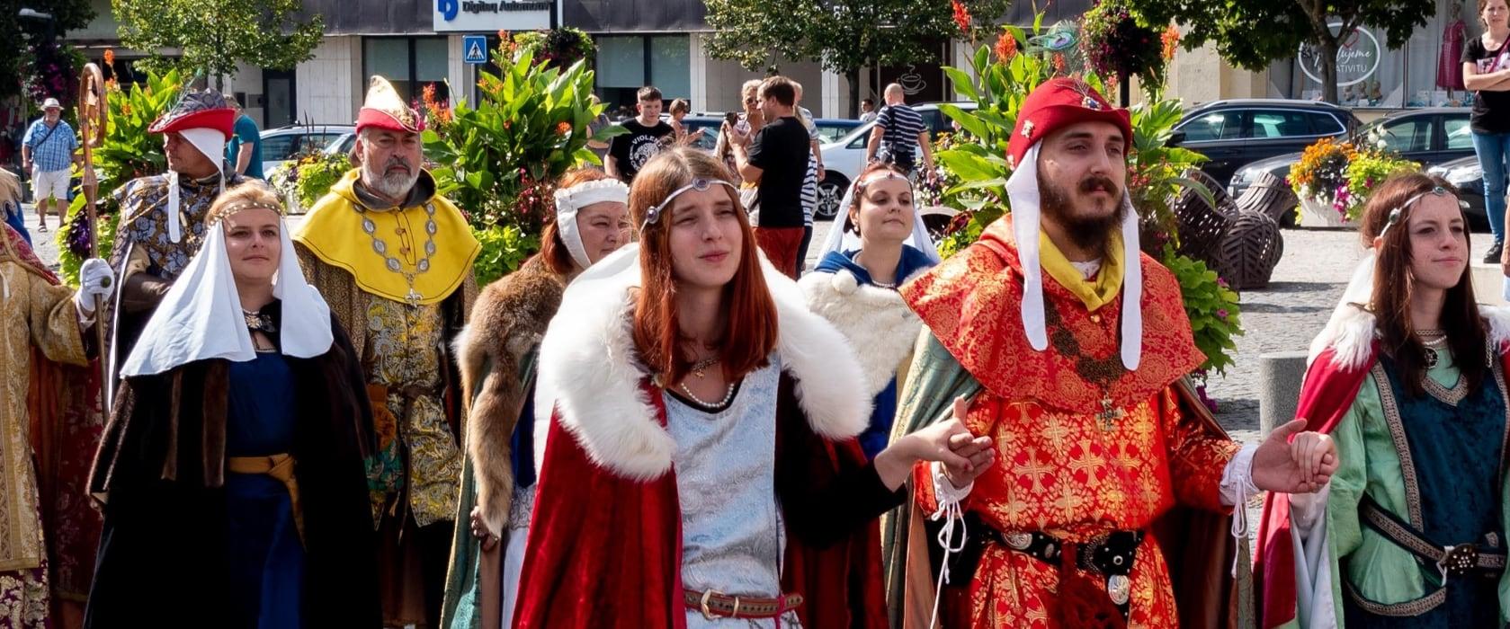 Králové, královny a jejich dvůr v dobových kostýmech procházejí městem